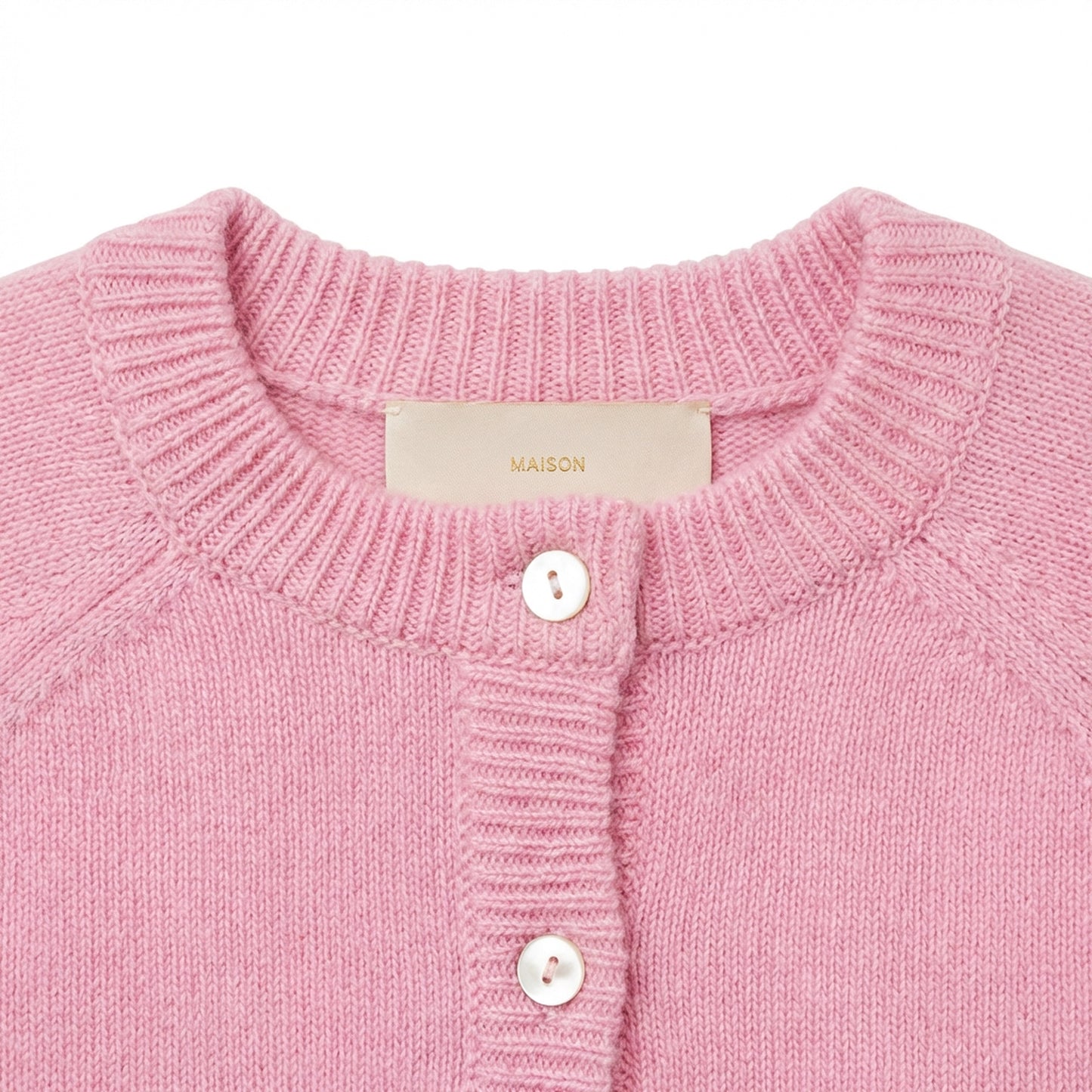 Detail of Maison Leopolda Cleo pink cashmere baby cardigan showing mother-of-pearl buttons